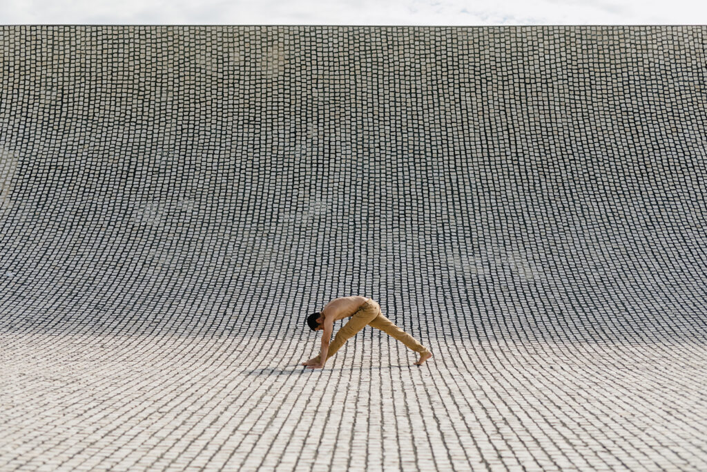 workout in minimal architecture Fitness sport man in fashion sportswear doing stretching exercise over minimal architecture