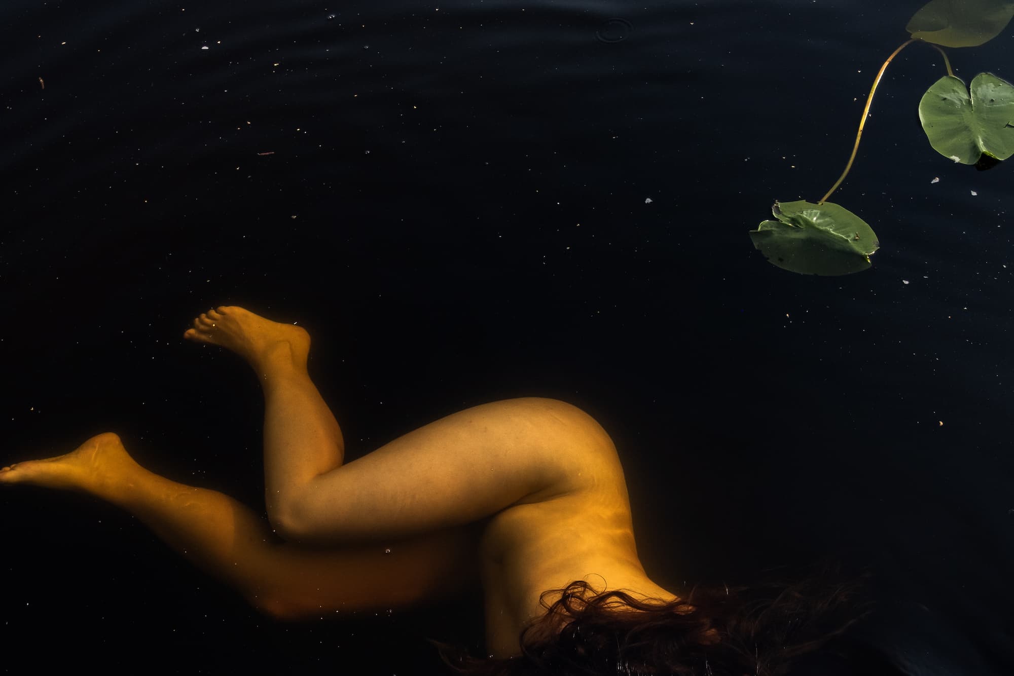 Lady bathing nude in the river water after sauna (banya)