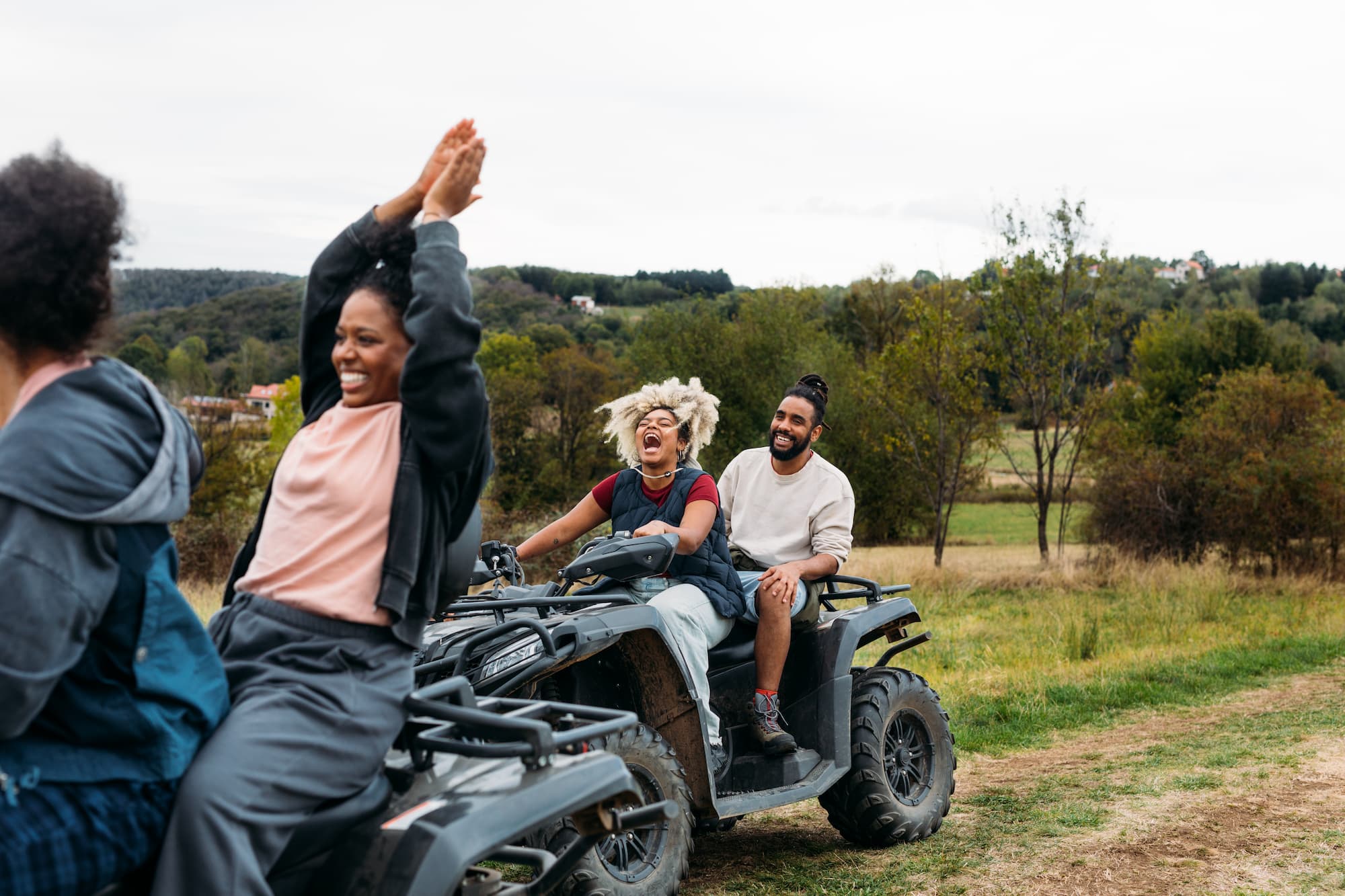 Two couples enjoying riding ATVs