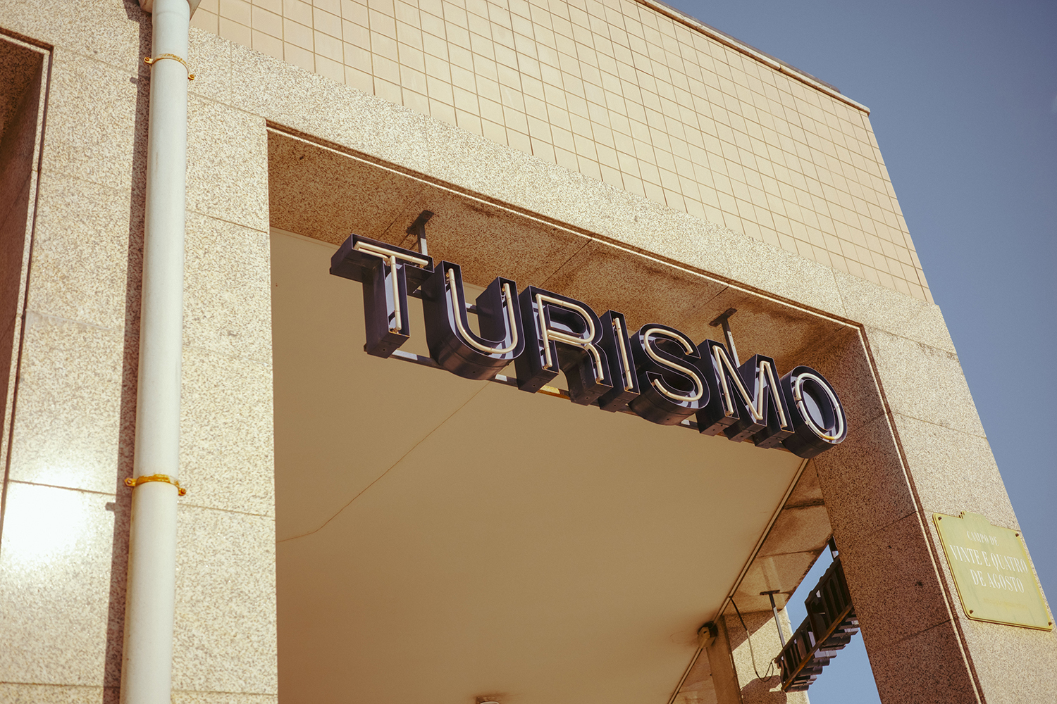 Turismo Sign Mounted on Tiled Building A Turismo sign made of black 3d letters is mounted in an arch of a tiled building in Porto, Portugal