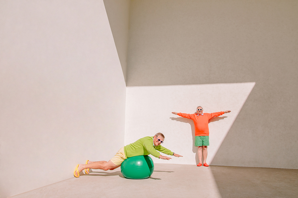 Colorful Older Men Pair of men in their 70s pose together in colorful clothing on a sunny day