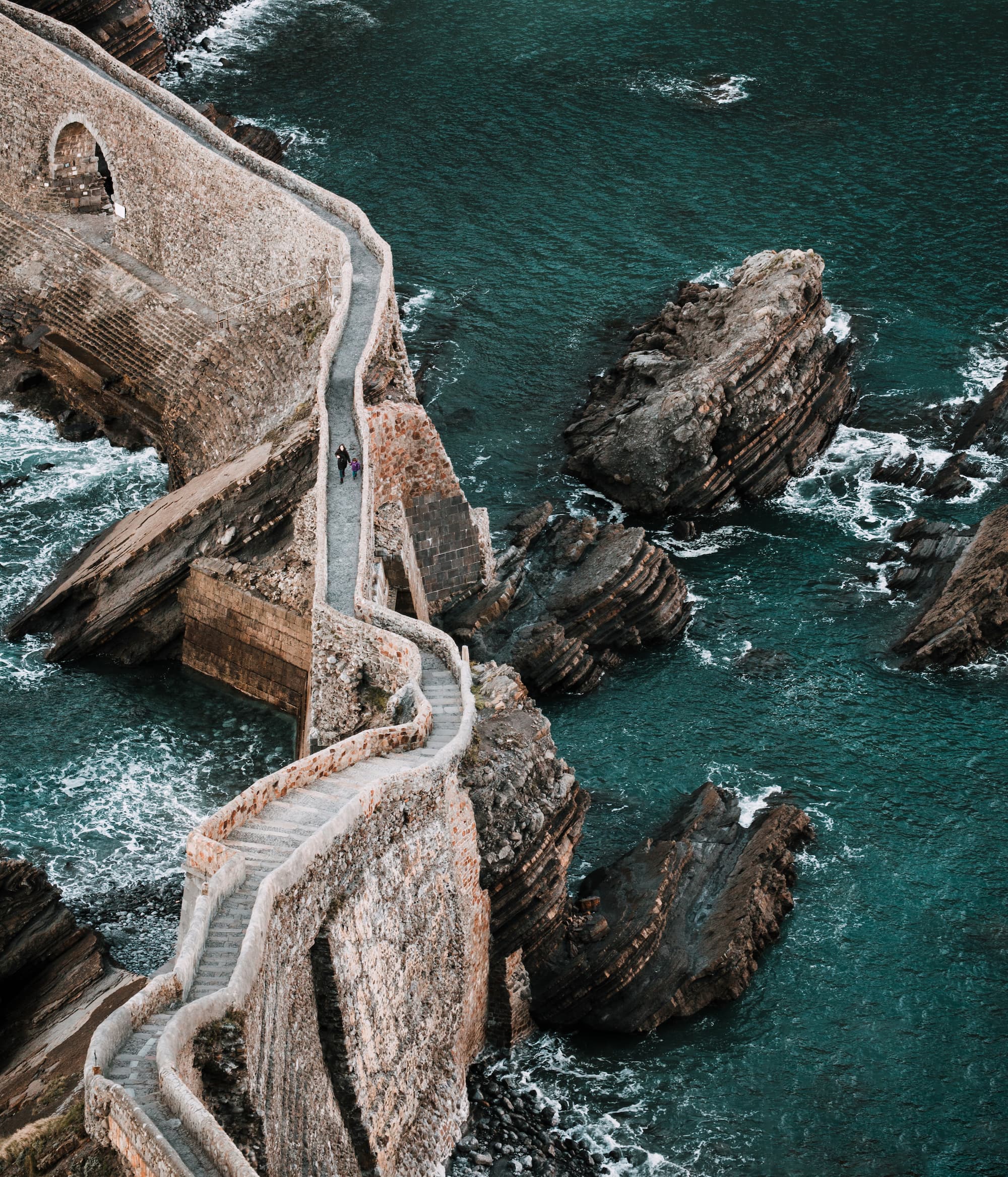 anonymous mother and daughter walking in Dragonstone (San Juan de Gaztelugatxe)