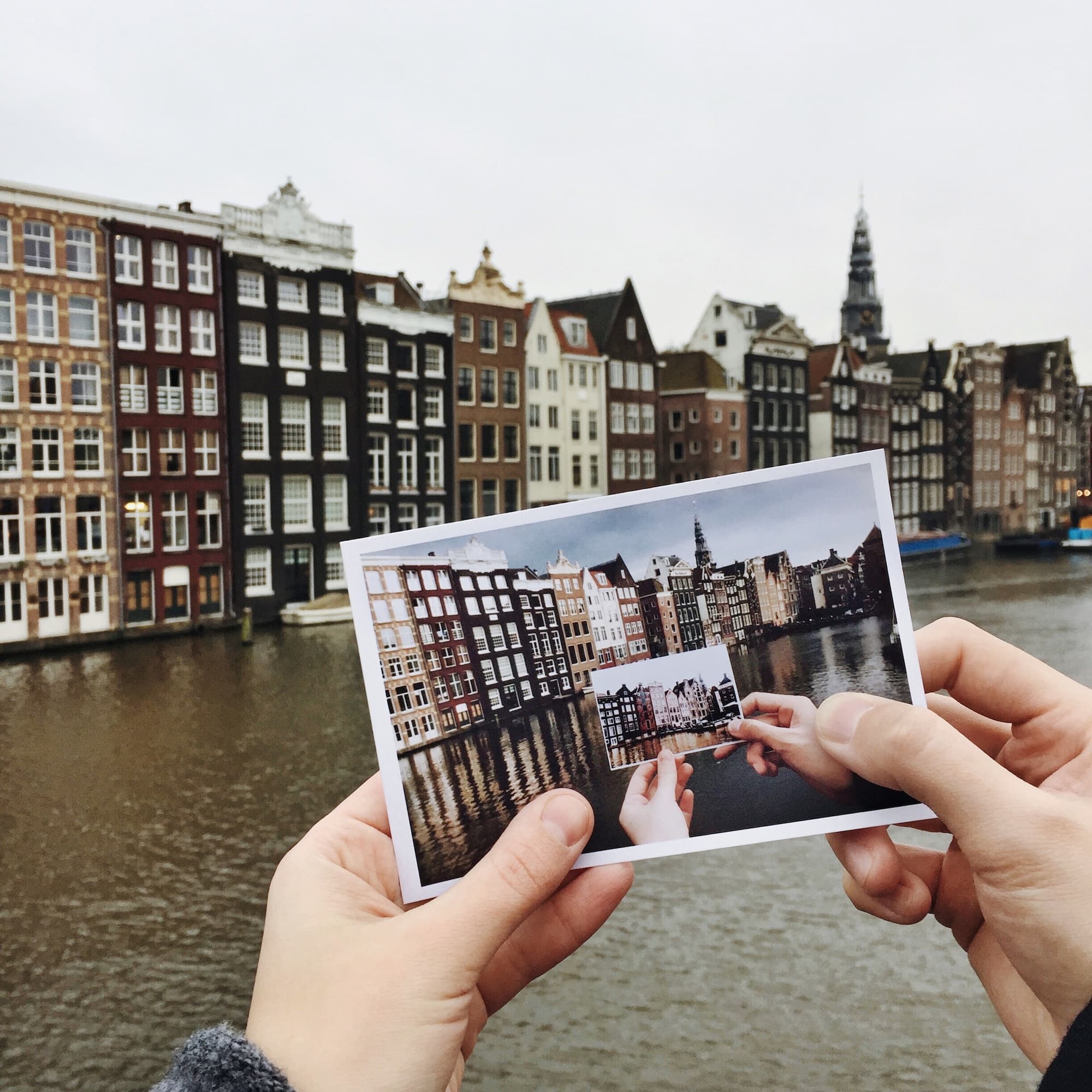 Recursion of Amsterdam canals Two hands holding the recursion photo