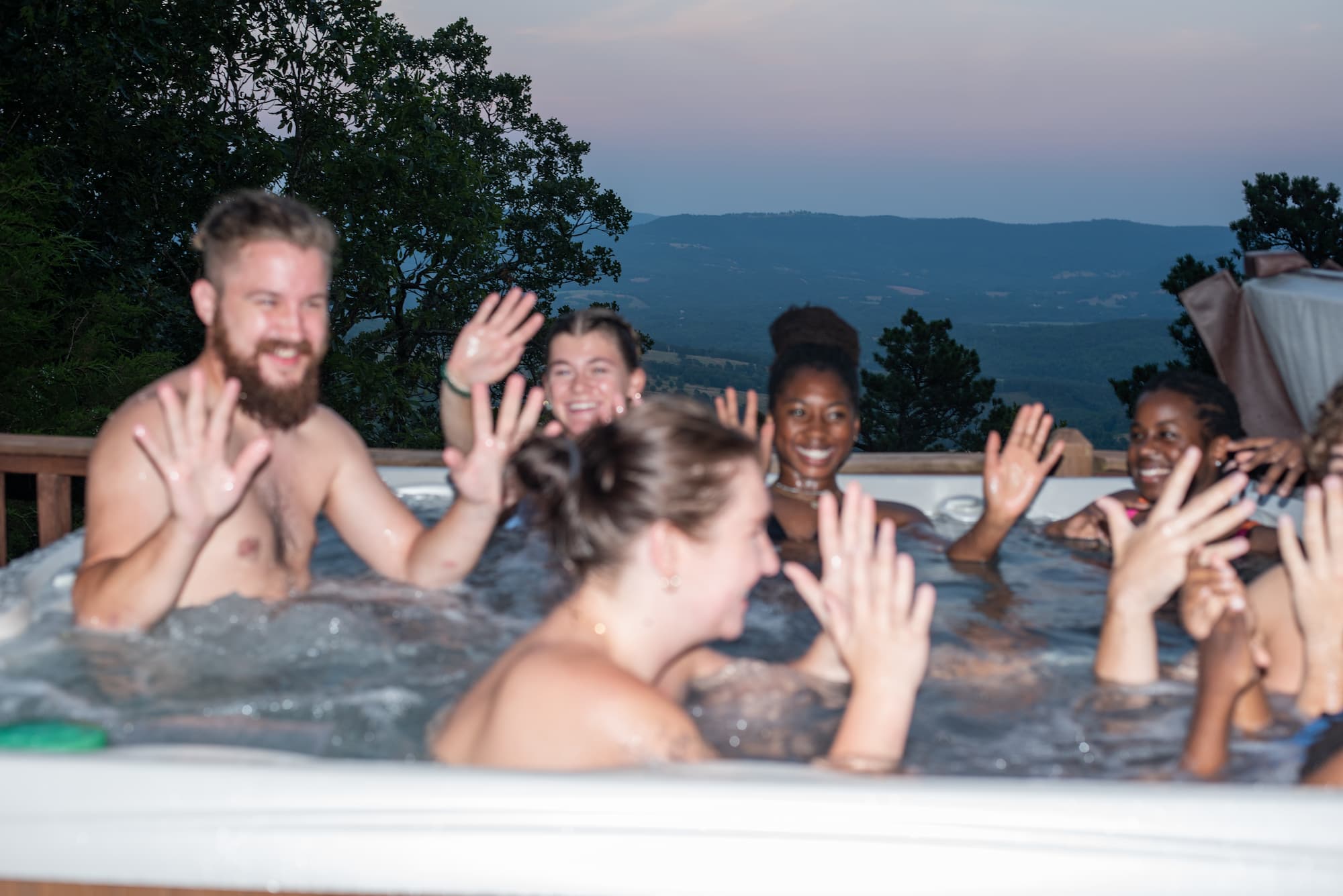 Group of teens in a hot tub Group of laughing teens having fun in a hot tub (blurred direct flash)