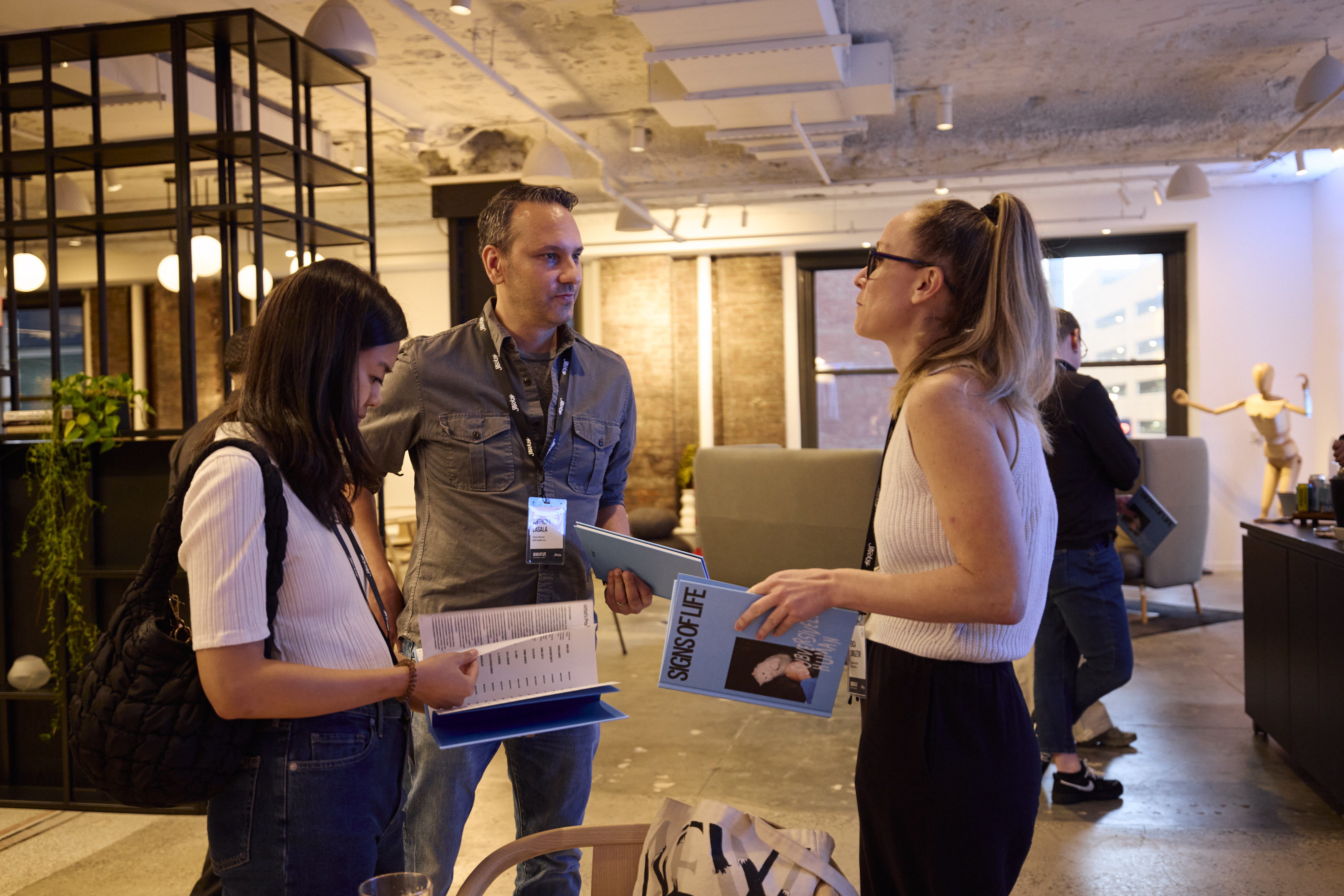2 women and 1 man in conversation at Stocksy's Signs of Life event