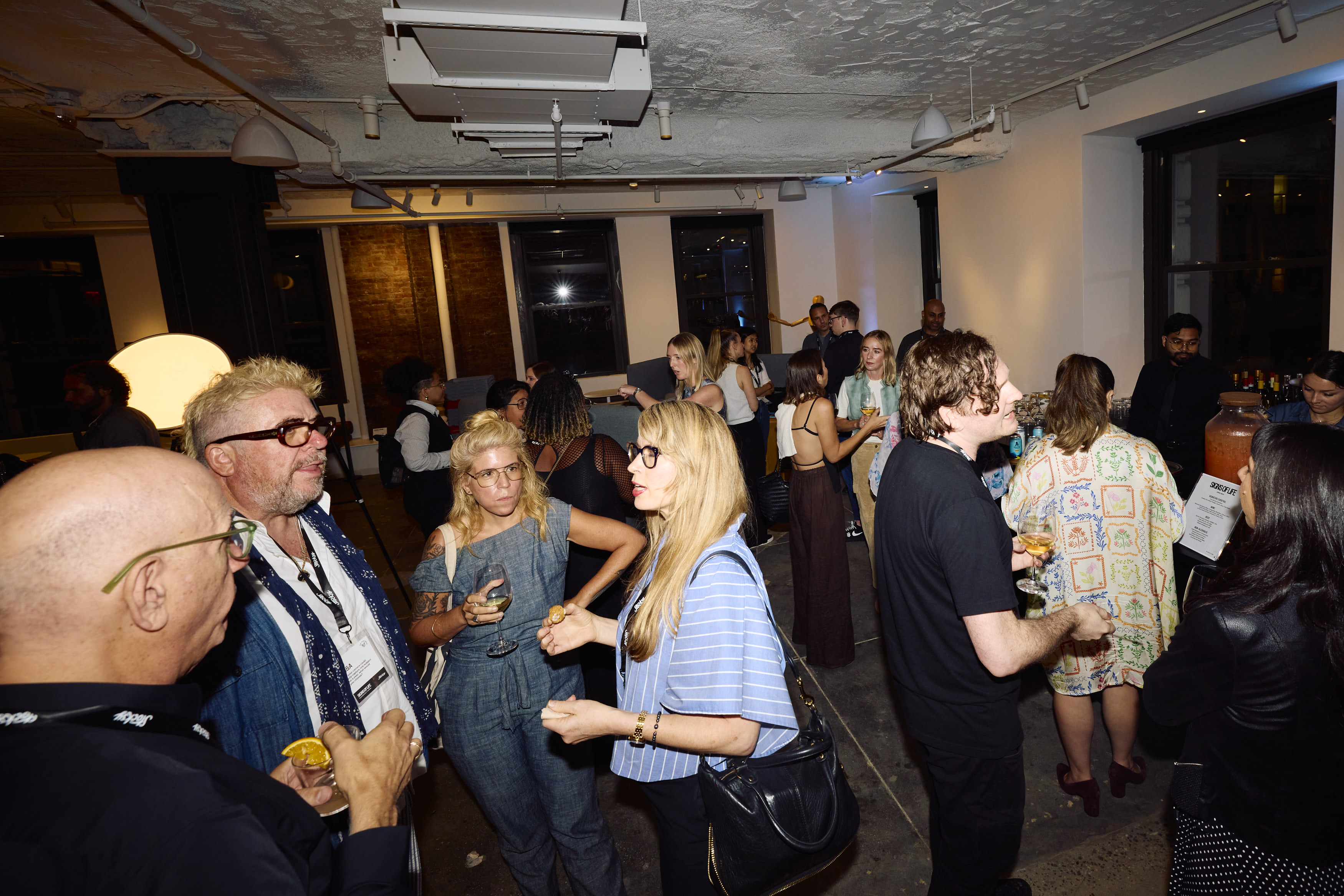 Guests mingling at reception of Stocksy's Signs of Life event