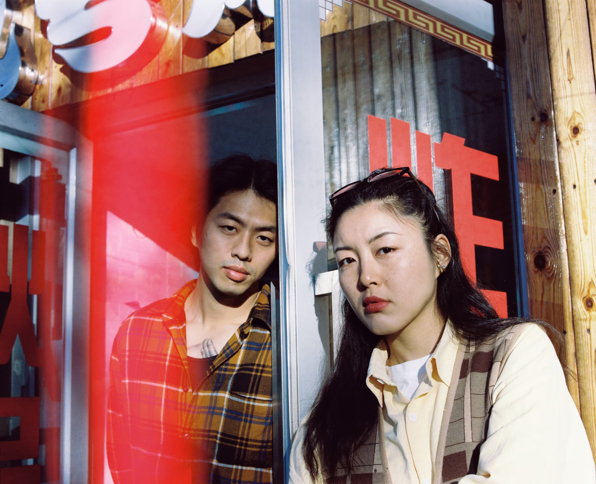 Young Chinese couple shot on film in the city of Qingdao, China during the day. They have a cool and relaxed attitude.